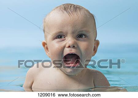 Stock Photograph - Unhappy baby in water. Fotosearch