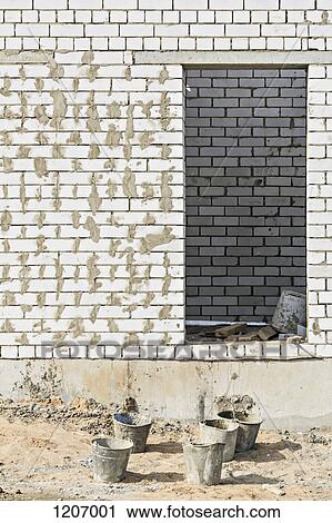 Used buckets in front of newly built wall View Large Photo Image Stock Image - Used buckets in front of newly built wall. Fotosearch