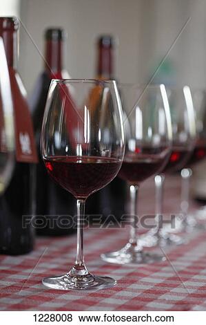 Various bottles of red wine with wineglasses in front at a wine tasting View Large Photo Image Stock Photo - Various bottles of red wine with wineglasses in front at a wine tasting. Fotosearch