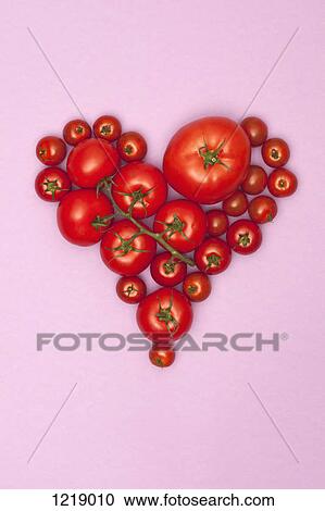 Stock Image - Various sizes of tomatoes arranged into the shape of a heart. Fotosearch