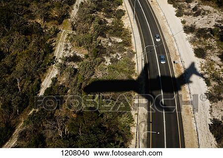 Stock Image - View of a highway and the shadow of a plane. Fotosearch