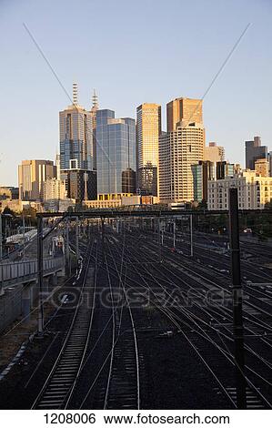 View of train tracks and city buildings, Melbourne, Victoria, Australia View Large Photo Image Stock Photograph - View of train tracks and city buildings, Melbourne, Victoria, Australia. Fotosearch