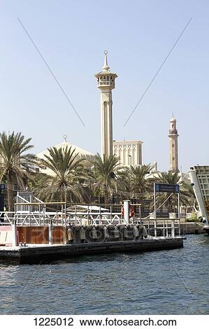 Stock Image - Water taxi dock and Grand Mosque in background in Bur Dubai, Dubai Creek, United Arab Emirates. Fotosearch