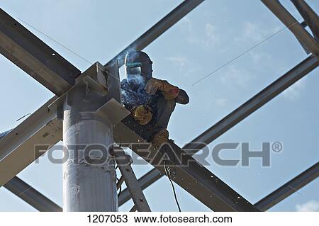 Welder high up on steel beam View Large Photo Image Stock Image - Welder high up on steel beam. Fotosearch