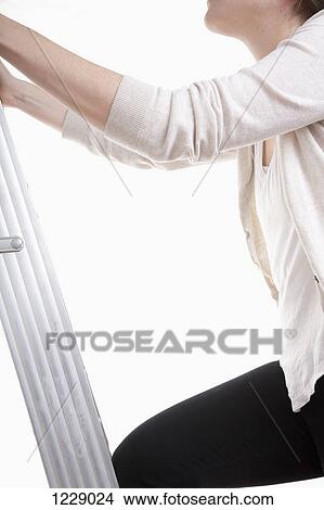 Picture -  Woman moving up the ladder. Fotosearch