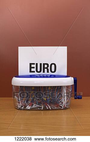 Stock Photo - Word 'euro' going through shredding machine. Fotosearch