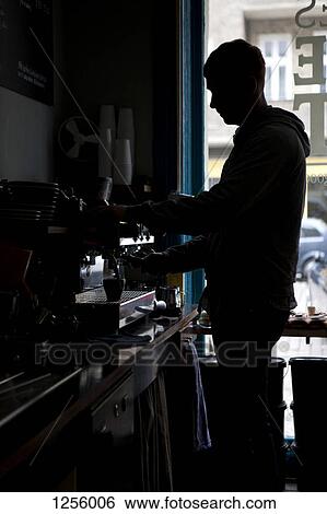 A barista making espresso at an espresso maker in a coffee shop View Large Photo Image Stock Photograph - A barista making espresso at an espresso maker in a coffee shop. Fotosearch
