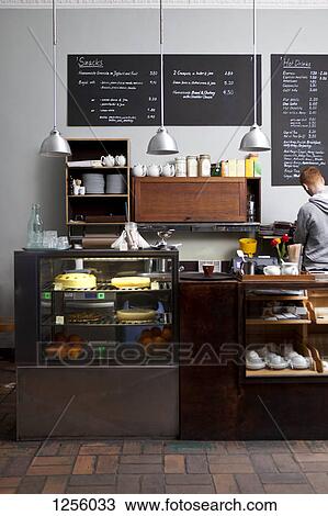 A barista working at an espresso maker in a cafe, rear view View Large Photo Image Stock Image - A barista working at an espresso maker in a cafe, rear view. Fotosearch
