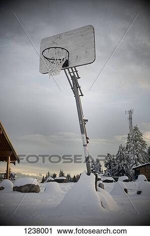 A basketball hoop in a snowy outdoor setting View Large Photo Image Stock Image - A basketball hoop in a snowy outdoor setting. Fotosearch