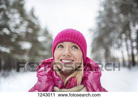 A beautiful woman in a knit cap looking up, outdoors in winter View Large Photo Image Stock Image - A beautiful woman in a knit cap looking up, outdoors in winter. Fotosearch