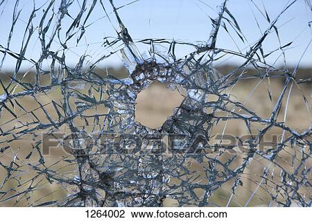 A broken glass window with hole in it View Large Photo Image Stock Image - A broken glass window with hole in it. Fotosearch