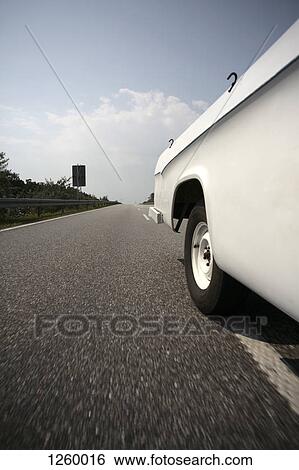 A car driving on a multiple lane highway, close-up, part of View Large Photo Image Stock Photograph - A car driving on a multiple lane highway, close-up, part of. Fotosearch