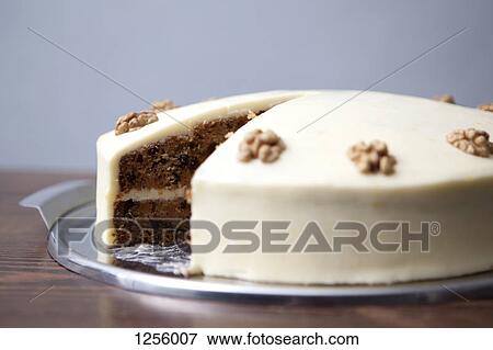 A carrot cake with a slice missing for sale in a cafe View Large Photo Image Stock Photo - A carrot cake with a slice missing for sale in a cafe. Fotosearch