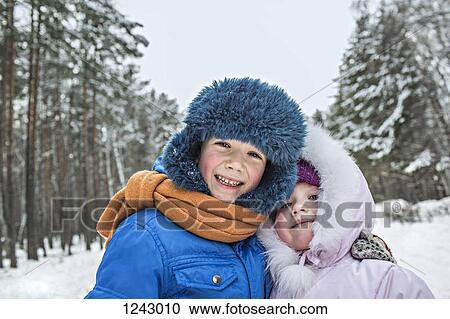A cheerful brother and sister in warm winter clothing outdoors in winter View Large Photo Image Stock Image - A cheerful brother and sister in warm winter clothing outdoors in winter. Fotosearch