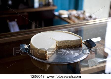 A cheesecake cut into slices on a display cabinet in a coffee shop View Large Photo Image Stock Image - A cheesecake cut into slices on a display cabinet in a coffee shop. Fotosearch