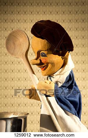 Stock Image - A chef puppet from the classic puppet show Punch and Judy cooking on stage. Fotosearch