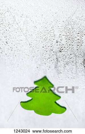 A Christmas tree decal on a window with condensation on it, close-up View Large Photo Image Picture - A Christmas tree decal on a window with condensation on it, close-up. Fotosearch