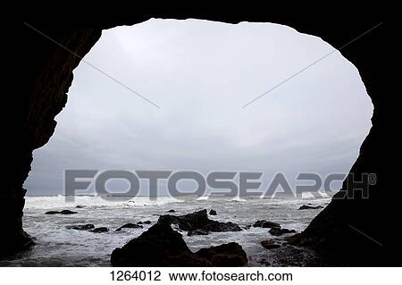 A cloudy overcast sky over the ocean seen from a darkened cave View Large Photo Image Stock Image - A cloudy overcast sky over the ocean seen from a darkened cave. Fotosearch