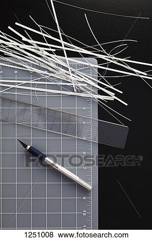 A cutting mat with shredded paper, ruler and utility knife on black background View Large Photo Image Stock Photo - A cutting mat with shredded paper, ruler and utility knife on black background. Fotosearch