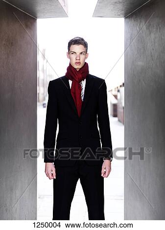Picture - A fashionable young businessman looking to the side . Fotosearch