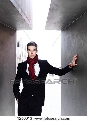 A fashionable young businessman posing between to walls View Large Photo Image Stock Image - A fashionable young businessman posing between to walls. Fotosearch