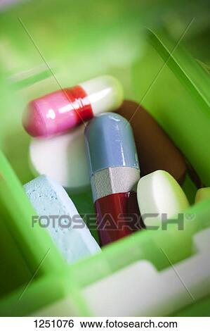 A heap of pills in an open pill organizer, close-up, full frame View Large Photo Image Stock Photograph - A heap of pills in an open pill organizer, close-up, full frame. Fotosearch