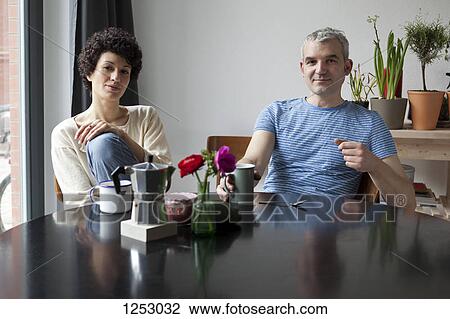 A hip mixed age couple having breakfast in their modern dining table View Large Photo Image Stock Image - A hip mixed age couple having breakfast in their modern dining table. Fotosearch