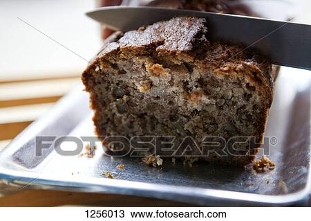 A knife cutting into a loaf of banana bread in a cafe View Large Photo Image Stock Image - A knife cutting into a loaf of banana bread in a cafe. Fotosearch