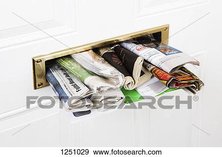A mail slot stuffed with mail and newspapers, close-up View Large Photo Image Stock Photo - A mail slot stuffed with mail and newspapers, close-up. Fotosearch