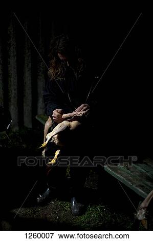 A man cleaning a dead goose in a dark shadowy scene View Large Photo Image Stock Photo - A man cleaning a dead goose in a dark shadowy scene. Fotosearch