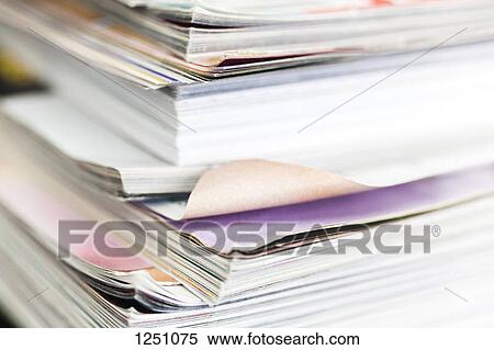 Stock Photography - A messy stack of well thumbed through magazines. Fotosearch