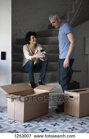 A mixed age couple packing moving boxes View Large Photo Image Stock Photo - A mixed age couple packing moving boxes. Fotosearch