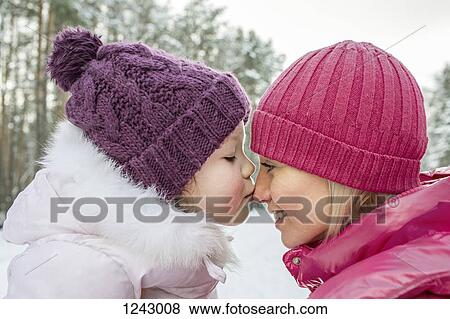 A mother and daughter wearing warm clothing, outdoors, face to face View Large Photo Image Stock Photo - A mother and daughter wearing warm clothing, outdoors, face to face. Fotosearch