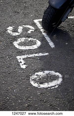 A motor scooter parked in a parking space with SOLO written next to it View Large Photo Image Stock Photo - A motor scooter parked in a parking space with SOLO written next to it. Fotosearch