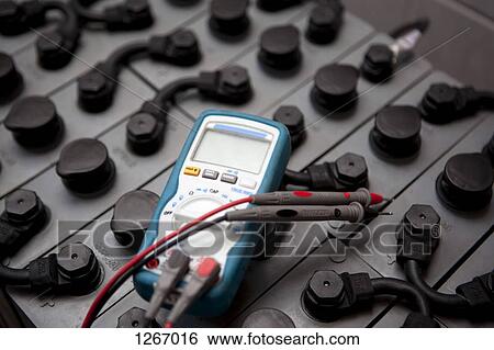 A multimeter lying on top of a battery used in solar powered energy View Large Photo Image Stock Photograph - A multimeter lying on top of a battery used in solar powered energy. Fotosearch