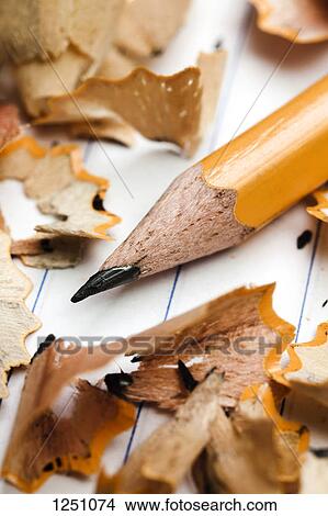 A pencil and pencil shavings atop lined notebook paper, extreme close up View Large Photo Image Picture - A pencil and pencil shavings atop lined notebook paper, extreme close up. Fotosearch