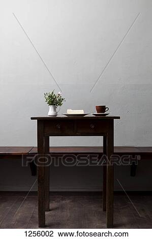 A piece of cheesecake, a cup of coffee and flowers on a table in a coffee shop View Large Photo Image Stock Image - A piece of cheesecake, a cup of coffee and flowers on a table in a coffee shop. Fotosearch