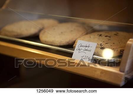 A price tag on a tray of chocolate chip cookies in a cafe display cabinet View Large Photo Image Stock Photo - A price tag on a tray of chocolate chip cookies in a cafe display cabinet. Fotosearch