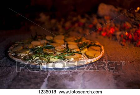 A rosemary and potato pizza baking in a brick pizza oven View Large Photo Image Stock Photo - A rosemary and potato pizza baking in a brick pizza oven. Fotosearch