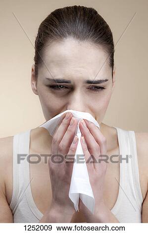 A sad woman crying and blowing her nose View Large Photo Image Stock Photo - A sad woman crying and blowing her nose. Fotosearch
