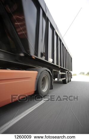 A semi-truck on a multiple lane highway View Large Photo Image Stock Photo - A semi-truck on a multiple lane highway. Fotosearch