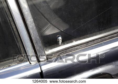 A skull shaped car door lock seen through a car window View Large Photo Image Stock Photography - A skull shaped car door lock seen through a car window. Fotosearch