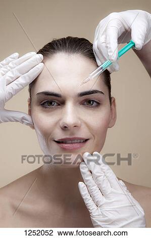 A smiling young woman receiving Botox injections View Large Photo Image Stock Image - A smiling young woman receiving Botox injections. Fotosearch