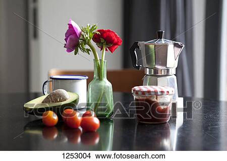 Picture - A table with espresso maker, coffee cup and ingredients for breakfast. Fotosearch
