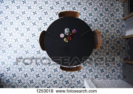 Stock Photo - A table with espresso maker, coffee cup and ingredients for breakfast, directly above. Fotosearch