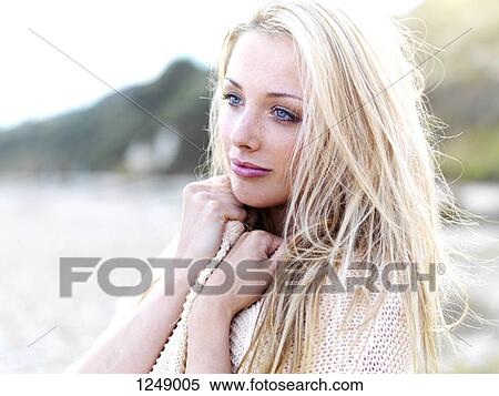 A teenage girl looking serenely away while standing on a beach View Large Photo Image Stock Photography - A teenage girl looking serenely away while standing on a beach. Fotosearch