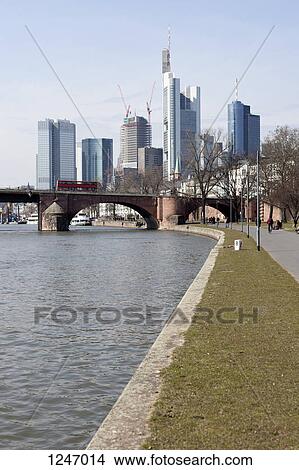 Picture - A tranquil park scene with a thriving and developing city in back, Frankfurt - Main, Germany. Fotosearch