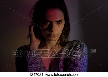 A woman looking suggestively into the camera while touching her hair View Large Photo Image Stock Photography - A woman looking suggestively into the camera while touching her hair. Fotosearch