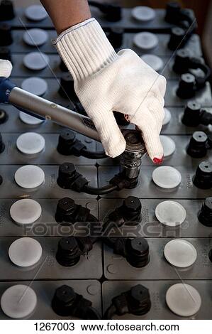 A worker tightening bolts on a solar power battery View Large Photo Image Stock Image - A worker tightening bolts on a solar power battery. Fotosearch
