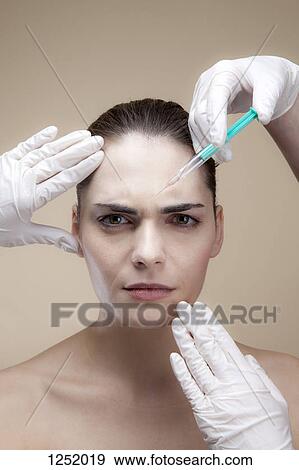 A worried looking young woman receiving Botox injections View Large Photo Image Stock Photo - A worried looking young woman receiving Botox injections. Fotosearch